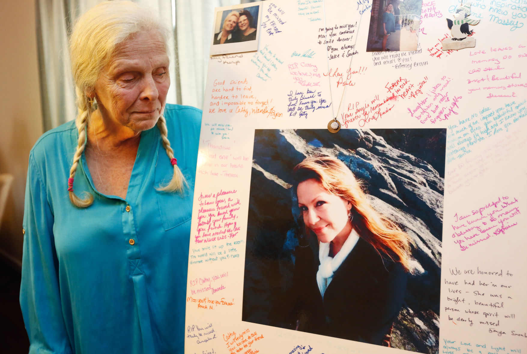 Wynette looking at photo of daughter'.jpg